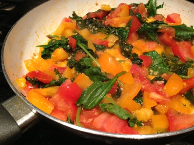 pasta with spinach tomato & feta tomatoes cooking